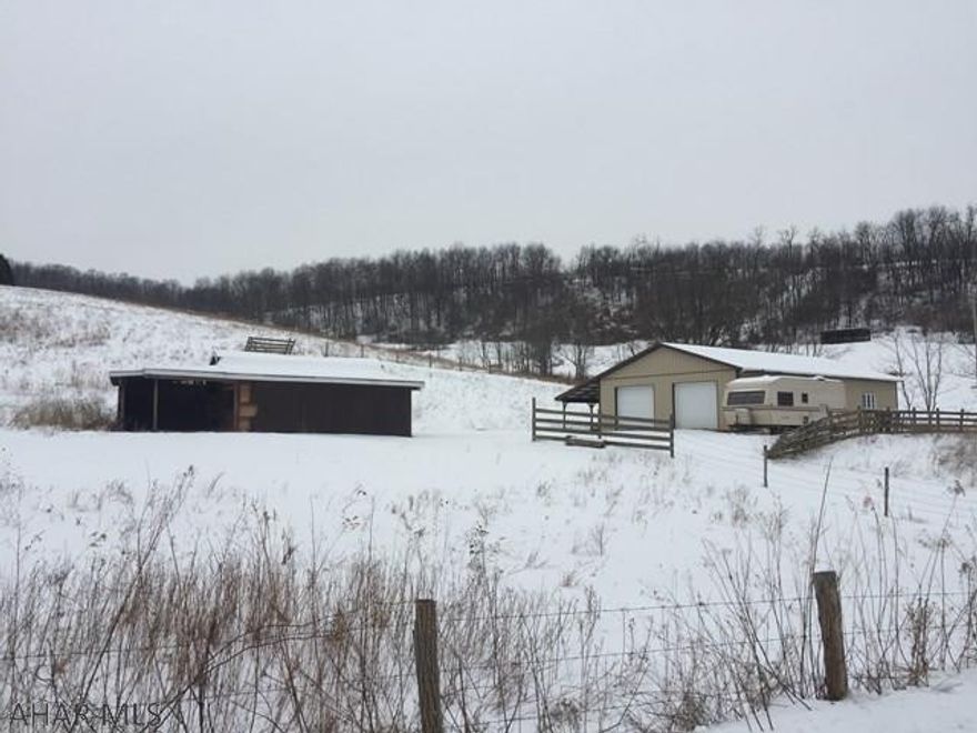 3 acres of mostly fenced ground with, steel pole building with 2 overhead doors & shed w/lean to. Public sewer & electric is available. Will need to drill well.