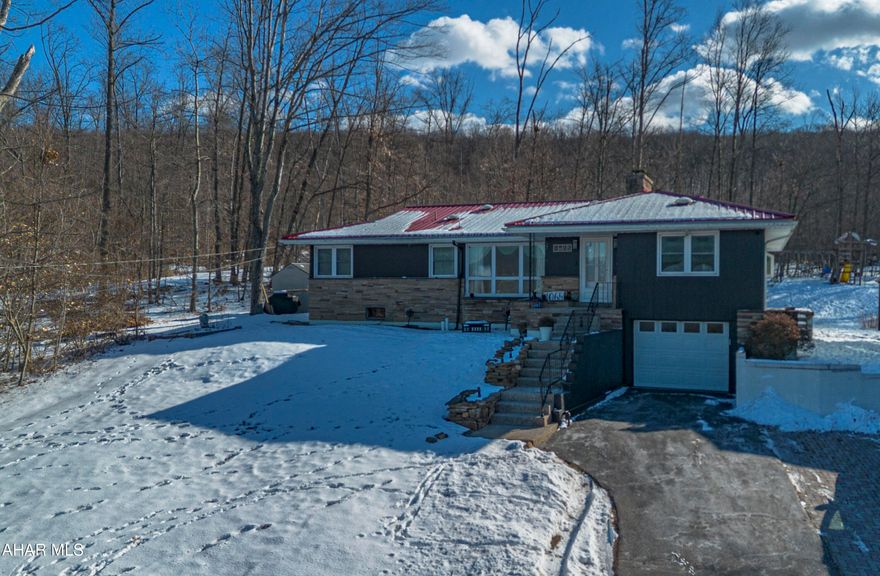 Well-maintained raised ranch ideally located just minutes from Interstate 99 for easy commuting and close to Logan Town Centre, offering nearby shopping and dining. This 3-bedroom, 2-bath home has been updated throughout and is truly move-in ready.

The main level features a bright and open living and dining area with plenty of natural light and a comfortable layout that flows into the kitchen, which offers granite countertops, ample cabinetry, and updated lighting. All bedrooms are well-sized and offer a warm, inviting feel.

The lower level provides excellent additional living space and includes a finished area currently used as a home gym, a second full bathroom, a laundry area, and access to the built-in one-car garage. Major improvements include a new furnace installed approximately one year ago, a newer hot water heater, a durable metal roof, and a recently repainted exterior.

Outdoor features include a covered rear patio, a firepit, and wooded views that create privacy, along with a rear sunroom equipped with a natural gas heater, allowing for comfortable year-round enjoyment.

A great combination of location, updates, and functional living space.