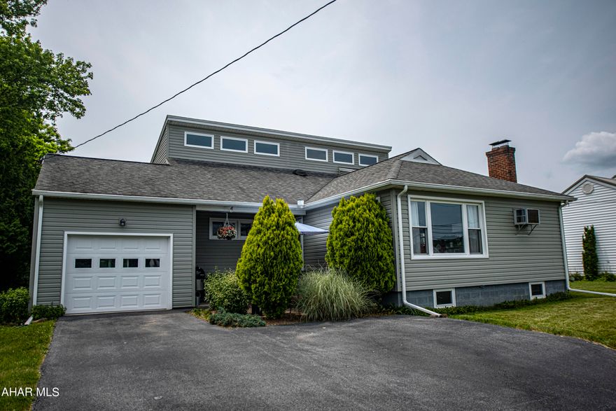 Remarkably unique 4 bedroom, 2 bath home for sale in the Frankstown area of Hollidaysburg. Every room has incredible custom touches. The second floor owners suite offers high ceilings, a walk in closet, walkout door to the private deck with a great view and a bonus room! The owners private bath has radiant floor heat and a huge tub shower. The first floor has an updated full bath, 2 large bedrooms with spacious closets, an additional bedroom that is currently used for an office with a custom built in desk. The modern/retro eat in kitchen is so much fun! Beautiful hardwood floors throughout! The back has a large fenced in yard with a patio. Well kept custom garden beds are in the back of the property full of flowers, herbs and vegetables. There is a second patio in front, surrounded by mature landscaping for extra privacy. Both the basement and large one car garage offer plenty of storage space. The updates are endless. A Matterport virtual tour is available. Schedule your showing today!