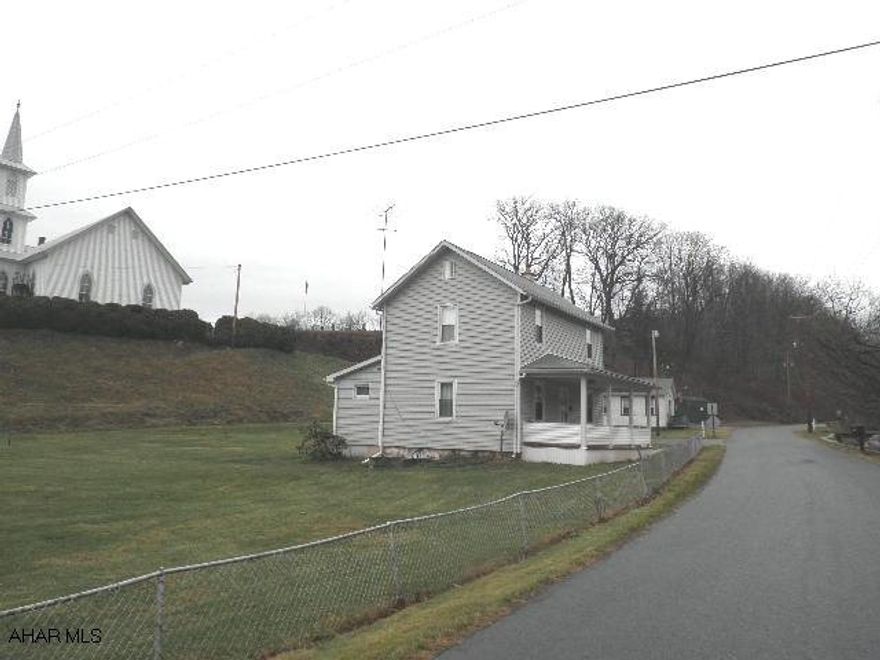 Great small town setting within walking distance of Blue Know State Park & pool. 3-car garage, stg.bldg.,& house.  Underground heat. oil stg. tank. *Real estate taxes are for land only; does NOT include house, garage or bldg.  *Approx. 0.57 acre based on a Dodson Subdivision Plat; NO WARRANTIES ARE IMPLIED.