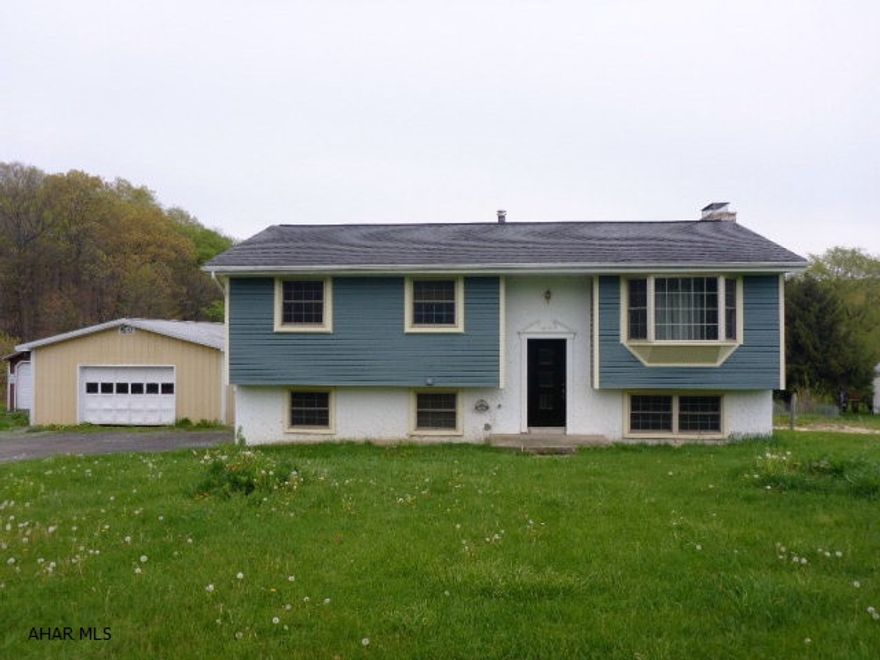 Do not delay! Fantastic 4BR/3BA home in Bellwood-Antis School District! Enjoy the large living room, dining area with glass sliding doors leading to the large rear deck to take in the awesome views, spacious kitchen, full bath and 3BRs on the main. While the basement offers a beautiful family room with tile flooring, knotty pine ceilings and gorgeous stone fireplace, along with a 3/4 bath. Retreat to the master bedroom offering 2 deep closets, master full bath and beautiful knotty pine ceilings. The large laundry room also doubles as a mudroom. The home has many updates along with newer siding and central vac. The massive garage is any garage lover's dream. And as a bonus, all of this is situated on 1.5 acres!!