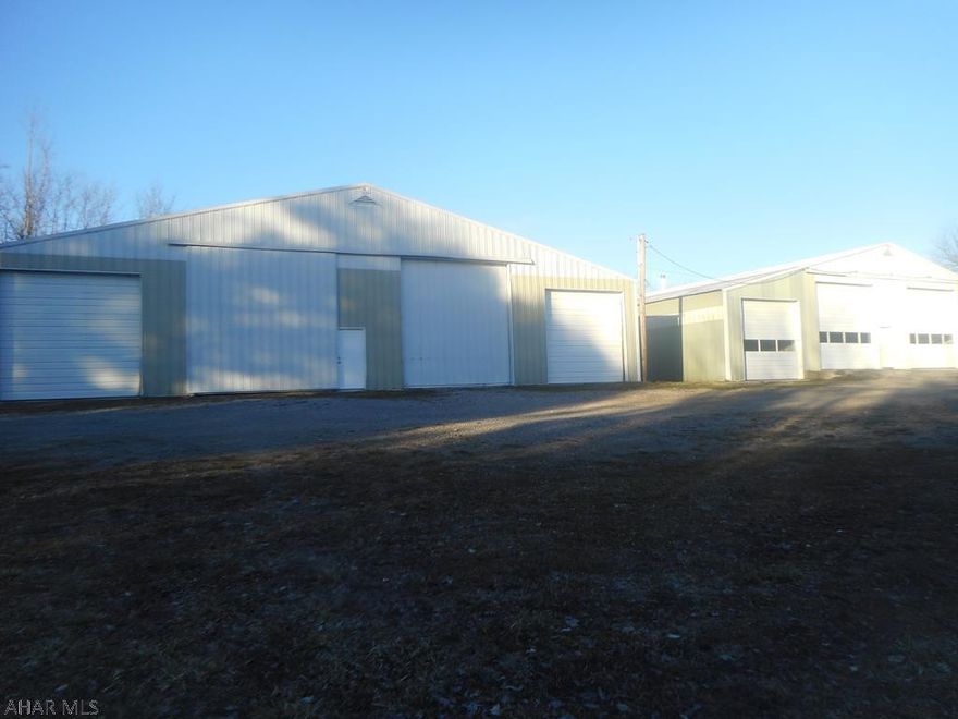 Two large garages and an office building on 1.764 acres. Garages measure 58x64 and 75x80. and total 9,712 sq ft.   Office building is 32x34.  Garages have electric - concrete floors.  R/W access on private road. Great trucking garages or sales/warehouse.