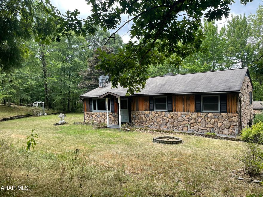 Secluded ranch style home with 2 acres in Logan Township. This 3 bedroom 1.5 bath home features: an eat-in kitchen, spacious living room with fireplace and bult-in gun case, floor laundry room with utility sink and closets, primary bedroom has a 1/2 bath. Plenty of closest throughout house.  Partial finished basement. Partial covered deck. Integral 1 car garage. Detached 1 car garage. 2 car carport. Shed.