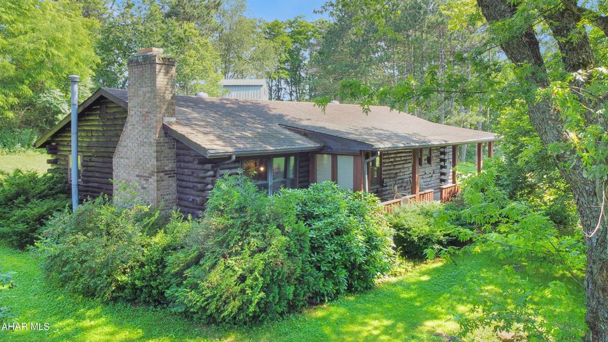Welcome to 730 Friend Lea Road, nestled in the Central Cambria School District. This stunning, one-of-a-kind log home exudes character both inside & out. As you step onto the main floor, you are greeted by a cozy living room that boasts a custom stone fireplace & an impressive cathedral ceiling. Adjacent to the living room, you'll find a charming dining area, a spacious kitchen, & two generously sized bedrooms. The main floor also includes a full bathroom w/ laundry hookups & a convenient mudroom. Venture down to the basement, where you'll discover a versatile living area that simply needs flooring, alongside a finished bonus room that could serve as a potential third bedroom. It also features a full bathroom & ample storage space along w/ your mechanicals. Sitting on approximately 1.8 acres, the exterior of this property offers a private driveway, a vast & serene lot, a welcoming covered front porch, & a carport. Don't miss your chance to explore this exceptional property, call today for more information!