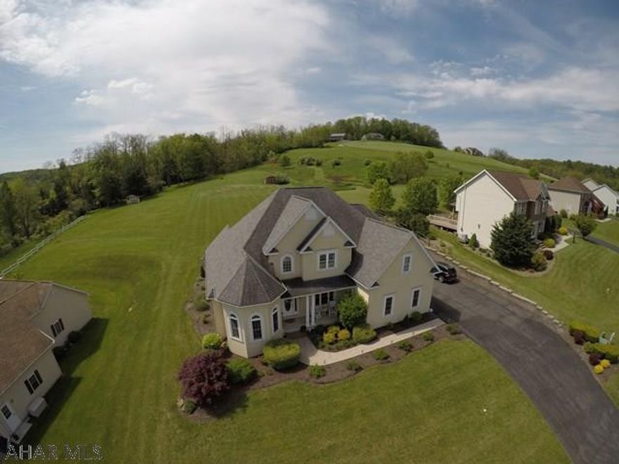 An incredible home with so much to offer from unique architecture to great hilltop views in Greystone Estates.  4 bedrooms and 3.5 bathrooms are just the start.  This home has an amazing open concept kitchen with stainless steel appliances and ceramic tile. Dining room has access to a newly remodeled rear deck with plenty of space to entertain and grill.  Living room with fireplace and vaulted ceilings.  Main level master bedroom with ensuite bathroom that has a soaking tub, separate glass shower enclosure, and his and her vanities. Main level bonus room that would make for a great office or play room. Full finished basement features a movie theater with stadium seating, bar area with lighting and hookups, full bathroom, and two separate storage rooms.  Integral 2 car garage and shed.