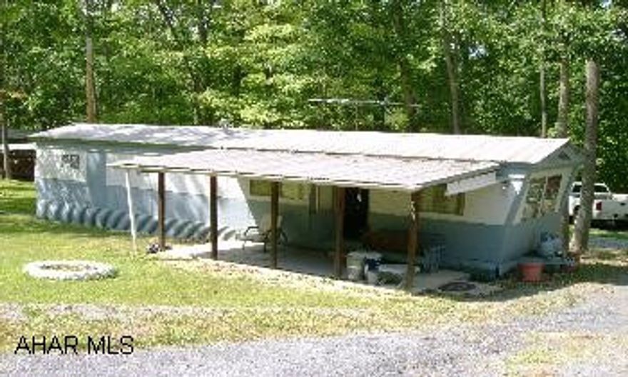 1967 Penn State 10' x 50' trailer with eat-in kitchen, living room, two bedrooms, and full bath.  Newer metal roof.  100 ampere electrical service.  Newer plumbing.  All furnishings included.  10' x 7' metal shed.