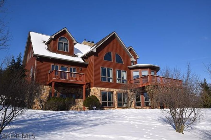 I promise you will swoon when you see the view from this fabulous home.  Complete privacy on the outside and beauty and comfort on the inside.  With over 5000 sq ft of finished living space, the entire family can spread out and do their own thing.  Huge great room with fireplace on main floor, and spacious family room with fireplace and rec area in lower level.  Really great home office with....that awesome view!!!    Quality construction and well thought out design with loads of natural light.  You will want to live on the screened porch in pleasant weather or take to the wrap-a-round deck to get some sun.  This is truly a one-of-a-kind home within walking distance to schools and library.  Let this Howard Hanna Home of Distinction be YOUR home of distinction.