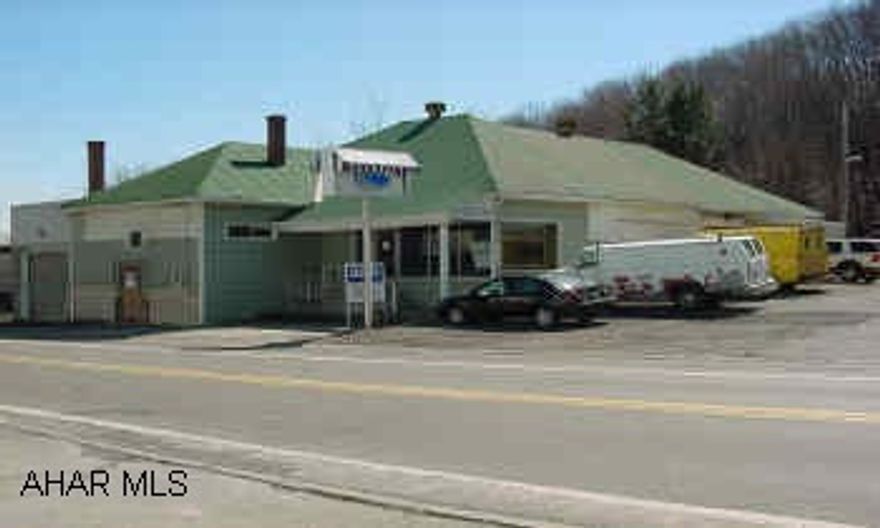 BLOCK BUILDING WITH 4 OVERHEAD DOORS AND SHOWROOM WITH 4 OFFICES IN LOGAN TOWNSHIP WITH LOW TAXES ($598/YR) ON ROUTE 36 REDUCED! COMMERCIAL INDUSTRIAL BUSINESS BUILDING WITH APPROX. 3,890 SQ. FT. WITH THREE 7' OVERHEAD DOORS AND ONE 10' OVER HEAD DOOR. ON BUSY RTE.36.  THERE IS A GLASS SHOWROOM AND 4 OFFICES. THERE ARE TWO 1/2 BATHS, CEMENT FLOORS AND PLENTY OF PARKING ON RT. 36. LOW TAXES! ($598/YR) CALL MIKE MANGIA (814) 946-4343 X 121