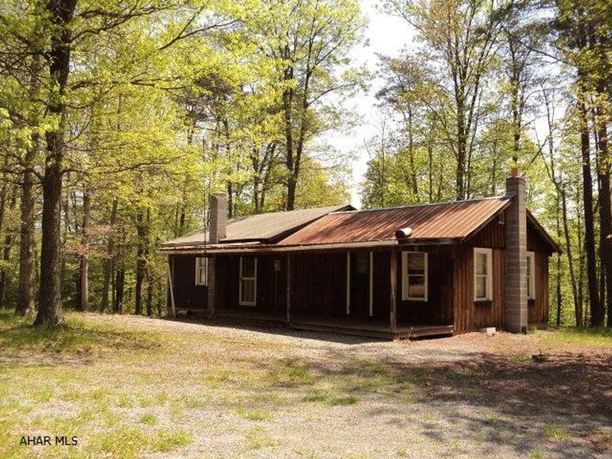 This property is a hunting camp and does require some TLC.  The interior is two very large rooms with a full bath.  There is a basement beneath a portion of the structure with a crawl space under the remainder.  The property offers seclusion yet is only minutes from downtown Huntingdon boro.  A prefect mountain retreat in the heart of Raystown country.  During inclement weather a 4 wheel drive vehicle is recommended. The access road currently to the property is not the established right of way.  Call for map showing the purposed right of way location.