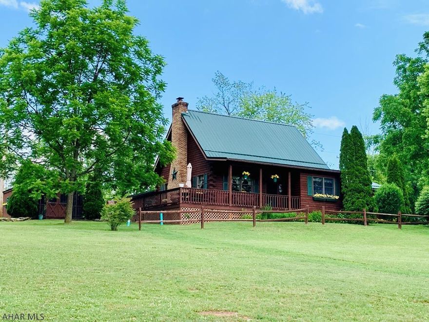 Lovely Custom Hand built Log home w/ a wraparound porch and beautiful views!  As you walk inside, enjoy the beauty of the hand crafted walls and cathedral ceiling, recess lighting and the stone fireplace. The loft offers another bedroom or sitting room w/ plenty of storage. The country kitchen has the solid oak cabinets,solid wood floors,rustic beams in the ceiling and dining nook to enjoy the views.The master suit features a den/office, 25 ft walk-in closet and full bath. Enjoy the out doors in the screened in gazebo, stove & Refrigerator hook ups.  The back of the garage features a heated den with 1/2 bath, electric and heat.  A one car garage with storage and workshop. Beautifully, manicured landscaping w/ flowers and garden touches.  Located near the PA turnpike, I-99, Dunnings Creek.
