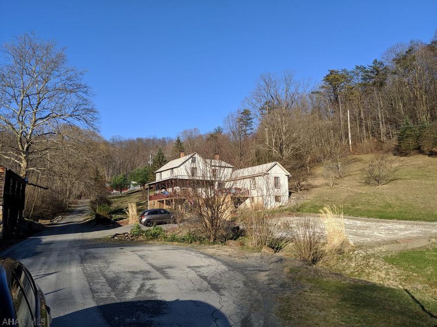 Fantastic farmhouse with some of the richest land to grow and farm yet close to town and is on city water and sewer! The land supports cattle and horses and you can even grow Christmas Trees!  Multiple barns are included on this 31 acre property with deer and turkey and all kinds of wildlife. Maybe you would like a hunting preserve or just enjoy the peace and quiet.  There is a stocked pond and multiple springs on the property as well. The house is a log home with multiple fuel sources including an outdoor furnace. You get so much for your home or vacation getaway. Don't forget to ask about the duck.