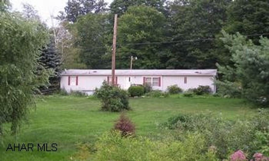 Large 3Br/2BA Doublewide on nearly 2 acres with stream and gorgeous array of flowers, trees and schrubs. Large master bedroom suite, huge living room, well lighted family room, big kitchen with ample cupboard space. Central air, skylights, enclosed porch, handicap access. Offered "As-Is"