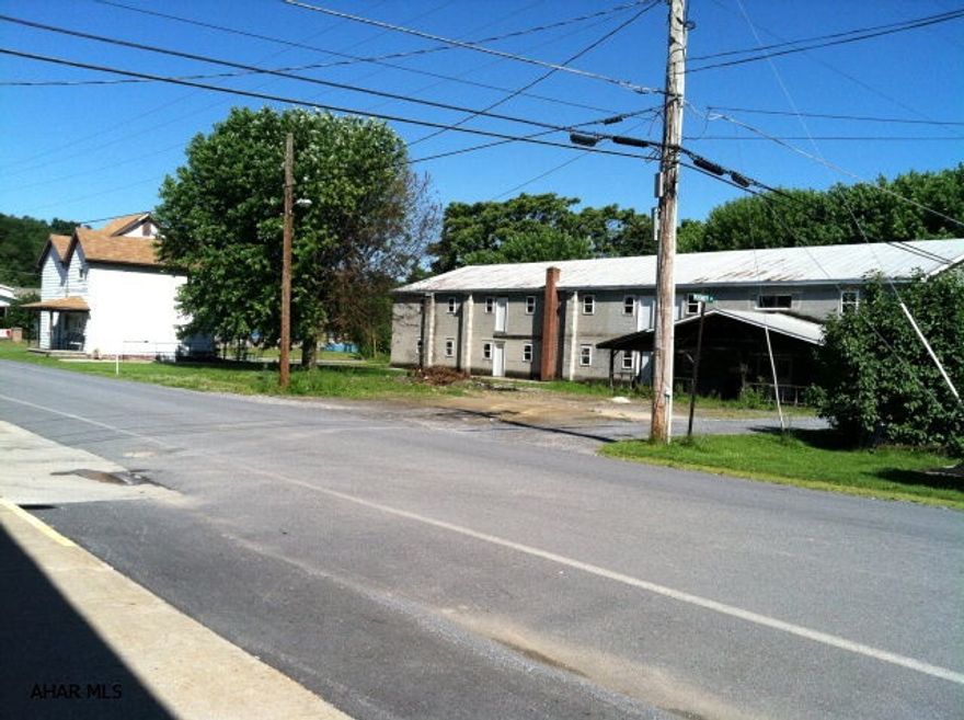This listing actually consists of 2 commercial properties - a commercial 2-story block warehouse-type building and a bonus residential house that has 3 bedrooms, full bath, LR, DR, K, and large laundry room. Rental house has oil hot air furnace.  Storage in the basement with outside entrance.  Current tenant has lease through 2/28/17 with Blair County Redevelopment and Housing Authority (COBRAH).  Rental payment is guaranteed $500 per month and tenant pays all utilities except sewer.  The stove conveys with the rental house.  The large block building could be rehabbed into any of many possibilities.  Apartments? Retail space?  Warehouse? STorage?