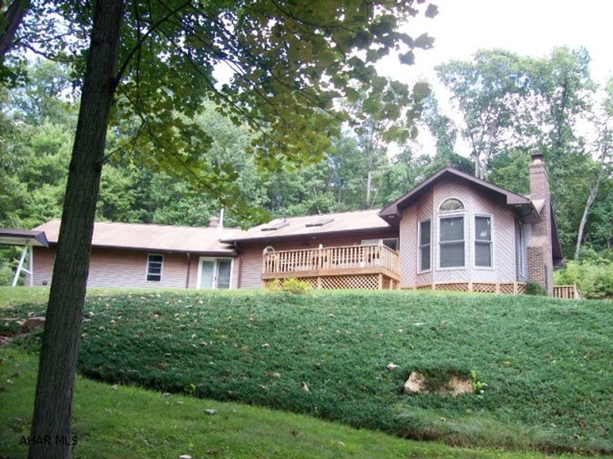 Centrally located between Altoona and Bedford. This custom built ranch sits on 12.35 acres. Very private secluded wooded acres. This home is a 1 owner home, immaculate condition, beautiful woodwork a must see. 2 large sheds 1 set up as a work shop. Both have electric and wooden floors.