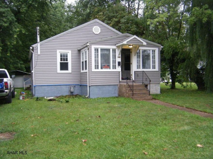 Small bungalow. Level yard, trees. Vinyl siding. Interior needs work.