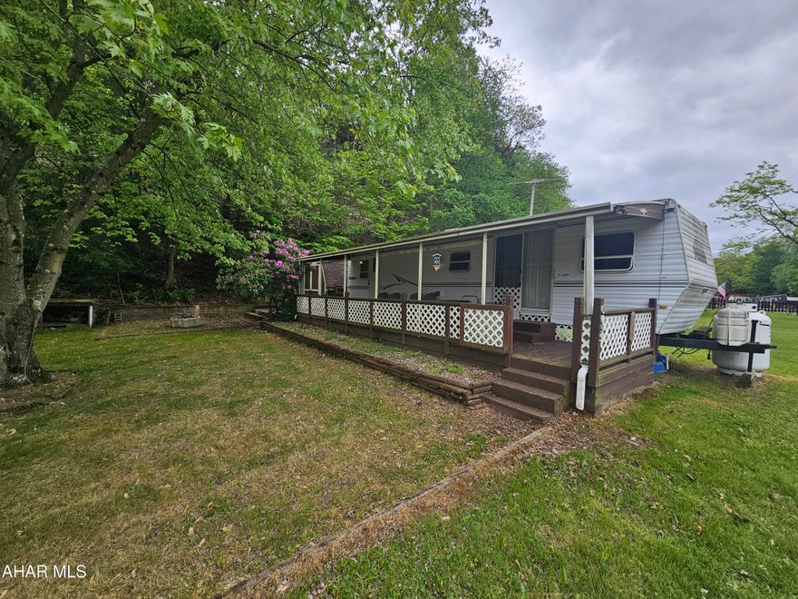 2000 38' Dutchman camper located on 2 lots inside Glendale Yearound. Camper is very spacious and has 2 bedrooms. Deck attached to camper with roof. 2 sheds on property and small pavilion with picnic table. Property is located inside Glendale Yearound, a gated community with public pool, basketball, tennis, security, and more.