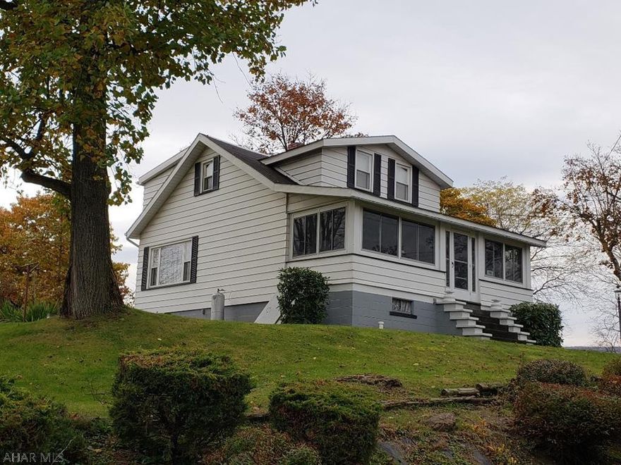 Nice 3-bedroom aluminum-sided Cape Cod with eat-in Kitchen, formal Dining Room, enclosed front porch, newer vinyl windows & nice view on double lot.  J-466