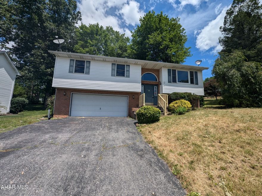 Bellaire Estates vinyl and brick Bi-Level home - Bellwood Antis School District! Features large formal living room, dining combo and oak kitchen w/ vaulted ceilings. 4 bedrooms, 2 bath and large rear covered deck. Basement finished w/ 1 BR, full bath, laundry/utility room and 2 car integral garage. Property sold AS-IS. Seller will make no repairs.