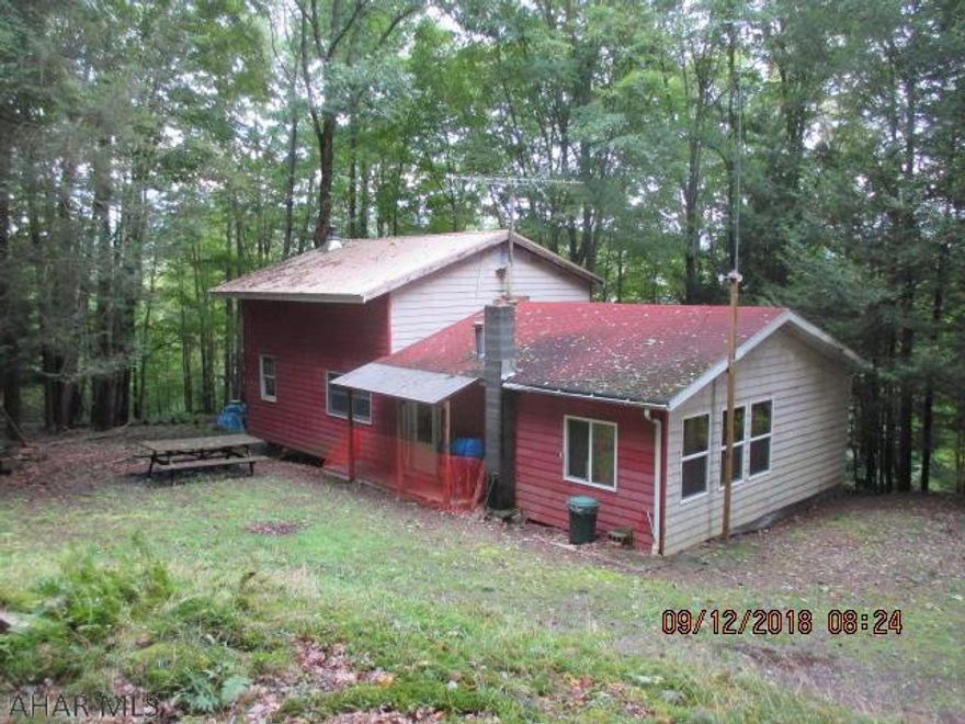 Secluded hunting camp or weekend getaway located on 24.913 wooded acres.  Perfect for hunting, recreation, or make it your primary residence.  Located in close proximity to Rock Run Recreation Area, State Game Lands, and trout fishing in Chest Creek.  Camp features newer two story addition featuring cathedral ceilings, wood burner,bar, and loft bunk area and the original camp consists of a bedroom, kitchen, 3/4 bath, and dining/living room.  These properties don't come up often.