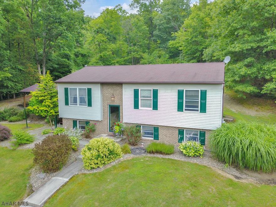 CLOSE TO AMENITIES BUT FEELS LIKE YOU ARE AWAY FROM IT ALL!!!  This well-kept Tyrone home is located on the end of 21st street, surrounded by woods.  Beautiful pavilions and decks in the private back yard give you plenty of outdoor space to entertain or enjoy the peaceful setting.  The home is a three-bedroom, one bathroom with 2033 square feet.  It has a nice three car detached garage.  THIS HOUSE IS A MUST SEE!!!