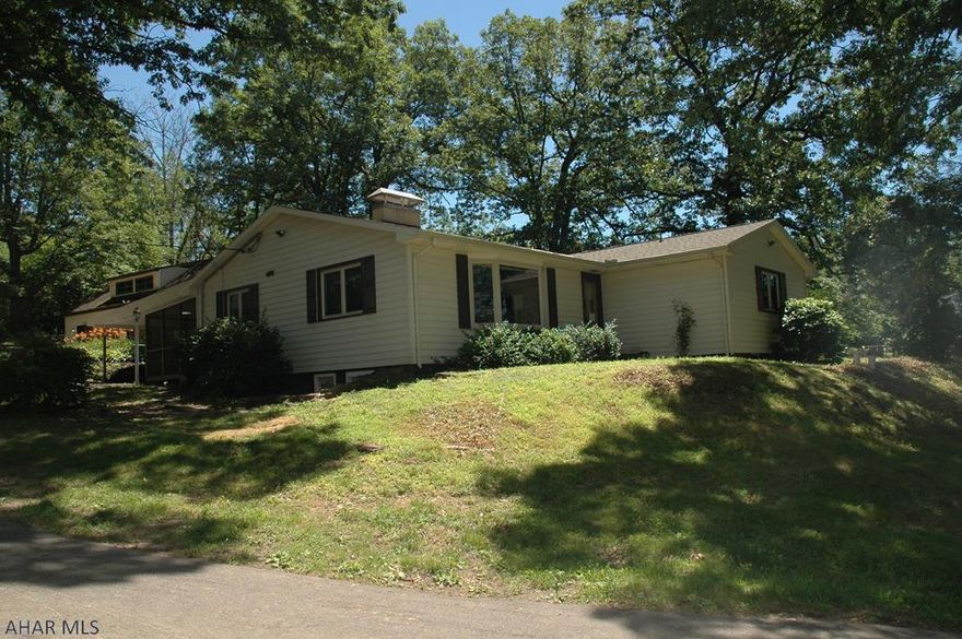 A rare find in Sylvan Hills, Hollidaysburg! 12+ wooded acres with spacious 1 story home and 4 car detached garage. Your chance to relax and be surrounded by nature, yet close to modern conveniences in fabulous Sylvan Hills. Features large eat-in kitchen, spacious formal living room with gas fireplace (or could be woodburning) along with 4 full bedrooms, 2 baths and laundry room all on the first floor. Relaxing screened patio off kitchen area plus large covered patio that can double as carport during winter months. Huge full basement includes finished family room with wood burning fireplace plus loads of room for other possibilities. 4 car detached concrete block garage is over-sized and includes second floor with walk-up stairs. Would make an excellent workshop or many other uses.