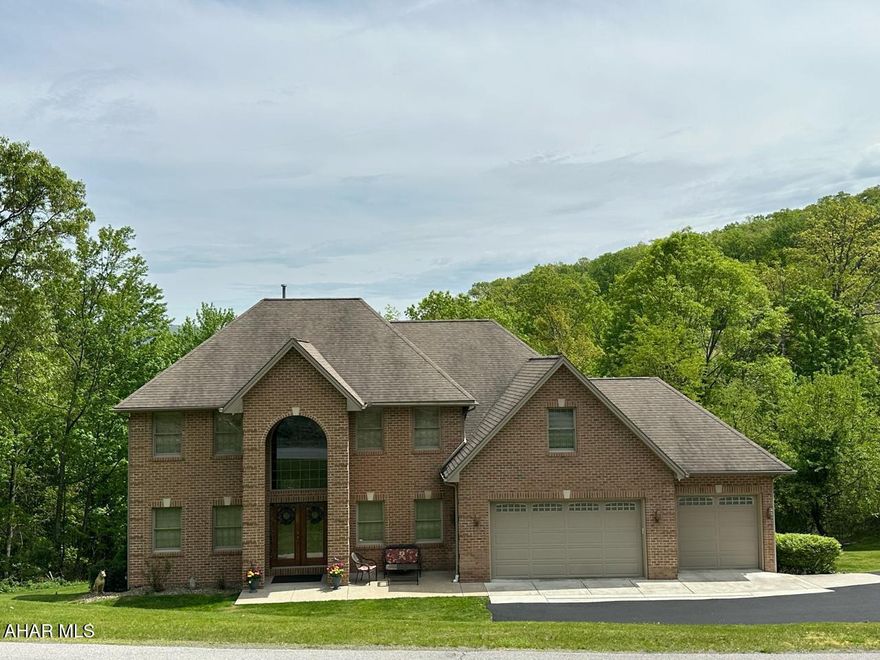 WELCOME TO 3406 GRANADA WAY! THIS STUNNING CUSTOM BUILT ONE OWNER  HOME IS LOCATED IN THE WOODED BEVERLY HILLS NEIGHBORHOOD ON JUST UNDER 4 ACRES OF MATURE OAK AND MAPLE TREES. PRIVACY IS YOURS IN THIS 4 BEDROOM 3 1/2 BATH HOUSE WITH 2 GAS FIREPLACES AND A THREE CAR GARAGE AND AN ADDITIONAL SERVICE GARAGE WITH ITS OWN DEDICATED POWER SUPPLY FOR THE HANDYMAN. THERE IS A FLEX ROOM OFF OF THE SECOND FLOOR LAUNDRY THAT COULD BE USED AS A 5TH BEDROOM.
THIS HOME BOASTS OVER 4700 SQUARE FEET OF METICULOUSLY MAINTAINED LUXURY. THE GRAND FOYER ENTRANCE WITH 20 FOOT HIGH CEILING WELCOMES YOU TO YOUR DREAM HOME.
TWO SEPARATE STAIRCASES LEAD YOU TO THE SLEEPING QUARTERS WHERE YOU WILL FIND OVERSIZED BEDROOMS WITH WALK IN WARDROBE CLOSETS. THE PRIMARY BATHROOM SUITE HAS A JETTED JACUZZI TUB ALONG WITH A HUGE WALK IN WARDROBE CLOSET.
THE MAIN LIVING AREA HAS AN OPEN FLOOR CONCEPT WITH A GOURMET KITCHEN WITH GRANITE ISLAND AND COUNTERS THAT FLOWS INTO A MODERN SUNKEN LIVINGROOM. JUST OFF OF THE KITCHEN IS A WALK IN BUTLER'S PANTRY WITH THREE LARGE SHELVED WALLS FOR EXTRA KITCHEN STORAGE AND A CENTRAL VAC SYSTEM.
THE SPACIOUS FORMAL DINING ROOM IS APPOINTED WITH OAK PLANK FLOORS FOR THOSE SPECIAL DINING OCCASIONS.
THERE IS A STUDY AND A 4 SEASON SUNROOM WITH OVERSIZED WINDOWS FOR ENJOYING THE SUNRISE AND SUNSETS  OR FOR JUST RELAXING WHLE WATCHING THE ABUNDANT WILDLIFE.
THE LOWER LEVEL IS THE ENTERTAINMENT DREAM WITH AN OVERSIZED TIKI BAR WITH SOLID SURFACE COUNTERS TO HOST BILLIARDS WITH FAMILY AND FRIENDS.
THERE IS ALSO A THEATER ROOM WITH BOSTON ACOUSTICS IN-WALL SPEAKERS TO FILL THE ROOM WITH THE HOME THEATER EXPERIENCE.
A MIRRORED WALL, EXERCISE/MECHANICAL ROOM WILL FIT ALL OF YOUT GYM EQUIPMENT AND ALLOW FOR EXTRA SPACE TO DO YOGA OR OTHER EXERCISES.
AS YOU WALK OUTSIDE FROM THIS LEVEL YOU WILL BECOME IMMERSED IN AN OUTDOOR OASIS. A COVERED AREA LEADS TO A FENCED IN HEATED FIBERGLASS POOL WITH WATERFALL AND CONVERSATION BENCH MOLDED INTO THE SHAPE OF THE POOL. 
THERE IS ALSO A POOL HOUSE TO STORE ALL OF YOUR OUTDOOR FURNITURE AND POOL TOYS. RELAX IN THE HOTSPRINGS HOT TUB THAT CAN BE OPEN AIRED OR COVERED WITH AN ELECTRIC OPEN/CLOSE RETRACTABLE AWNING.
STEPS LEAD TO A BONFIRE AREA WHERE YOU CAN WARM UP ON THOSE COOL NIGHTS WHILE MAKING MOUNTAIN PIES AND SIPPING ON YOUR FAVORITE BEVERAGE. FOR THOSE WITH A GREEN THUMB, THERE ARE TWO GARDENS WITH A WATER SUPPLY TO PLANT YOUR SPRING FLOWERS OR VEGETABLES. 
THE OVEN AND DRYER HAVE DUAL HOOK UPS FOR EITHER ELECTRIC OR GAS.
THIS HOME TRUELY HAS IT ALL! WITH A SHORT DRIVE TO UPMC ALTOONA, PENN STATE ALTOONA CAMPUS AND INTERSTATE 99 YOU CAN LIVE IN SERENITY AND STILL HAVE ACCESS TO THE NECESSITIES FOR LIVING!