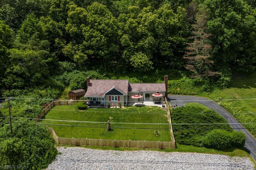 The welcome mat is out for this cozy move-in ready home with numerous upgrades, conveniently located close to Southside Elementary. You're sure to love this charming 3 bedroom home, ideal for a year round residence or a second home, only 10 minutes from Raystown Lake. The living area has a Vaulted ceiling with sliders to the new patio area, great for outdoor entertaining with a large fenced in yard.  The luxury vinyl plank flooring in the living room add to this spacious room adjacent the newly remodeled kitchen with granite counter tops. Enjoy the view drinking your morning coffee at the bar in the kitchen.  The newly renovated bedroom on the second floor is sure to please with tongue and groove and hardwood flooring. Don't miss the adorable new 3/4 bath in the basement. You'll love it!