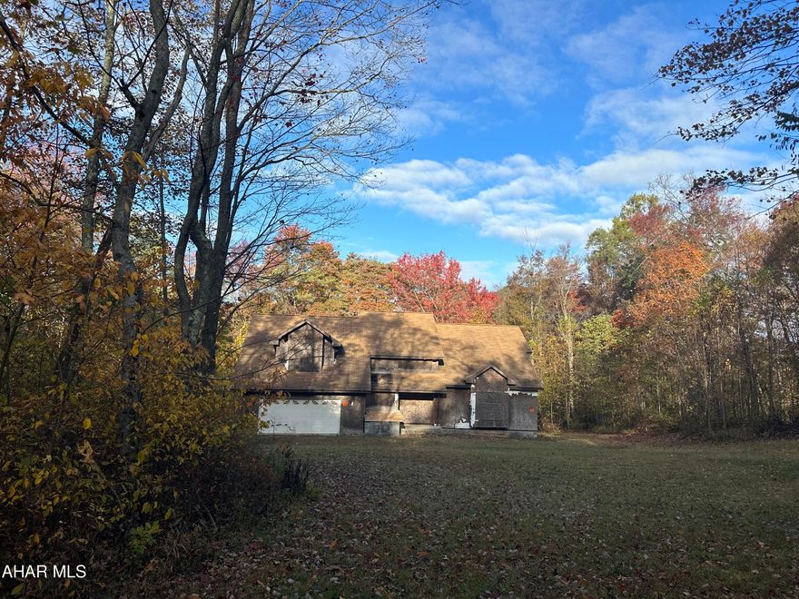 Pristine 42 acres, very private wooded acreage with unfinished house, stream meanders through the property, house is under roof with windows, full basement with stone floor, lots of potential in this spacious 1 1/2 story, well and septic are installed, electric needs run to property, dirt road access