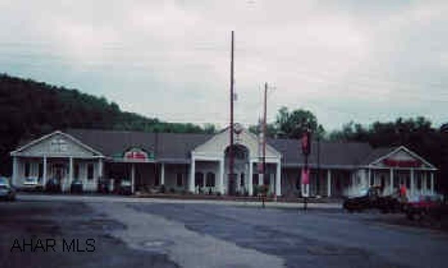 Neighborhood business center complex fronting US 30 in Bedford, PA with stucco exterior on 2.16 acres.