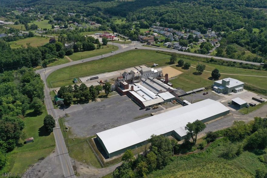 100,000 square feet of manufacturing and distribution buildings. Property consisted of 36 acres, had heavy electrical power to the site and rail service. No zoning and easy access to I-99. Property was fenced with abundant outside storage areas.