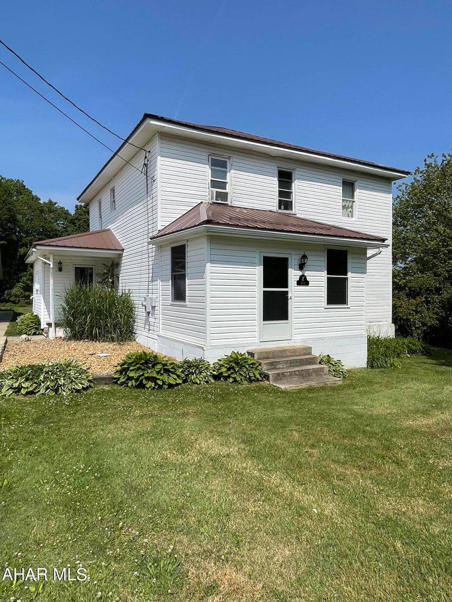 If you are looking for a spacious home to entertain family and friends both inside and out then this is the home for you.  This 4 bedroom 2 bath home on a flat  2.3 acre parcel has had many updates throughout.  Step inside the large first floor laundry/mudroom to take off shoes and coats.  The expansive kitchen has plenty of counter space to prepare meals and there is no shortage of storage with lots of cabinets and a pantry.  The kitchen can accommodate a large table.  There is a 3/4 bath on first floor for guests when entertaining.  Also on this floor is a dining room off of the kitchen with built in shelves, a nice sized living room and a sunroom.  The second floor features four large bedrooms and one full bath.  There is plenty of closet space in this home.  Outside you will find a newer metal roof and an oversized two car garage with a loft above for possible game room/media room and also a room that houses the outdoor furnace.  House also has an oil furnace in the basement.  There is a large covered patio area behind the garage perfect for summer picnics.  Come stretch your legs and see this property.