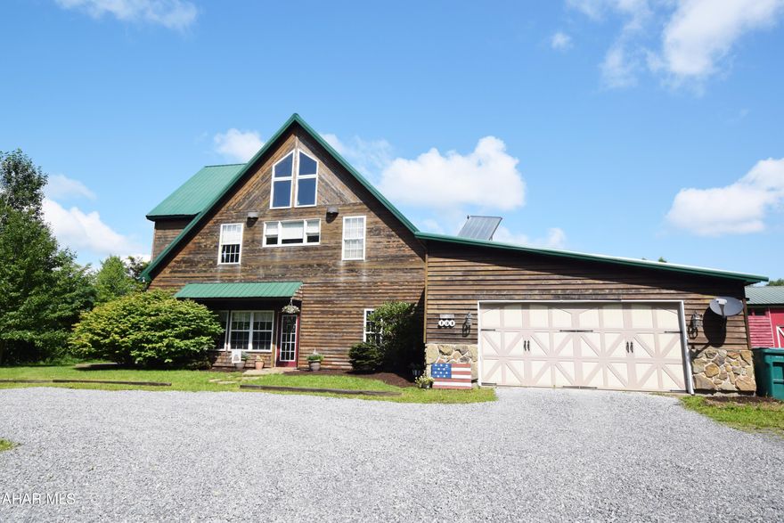 If country living on 18.80 acres only 15 minutes to the city is your thing, this stunning log home is the one you've been looking for.  Over 4,500 square feet of beautiful living space.  Huge country kitchen with granite counter tops and plenty of storage.  Formal dining room.   Formal living room.  Great room with 30 foot windows offers incredible views of the surrounding mountainside.  Also on the main level is a full hall bath, laundry room, and owners suite with full bath.    The second level features a loft area that overlooks the great room that would be perfect for office or homework station.   This level also features two bedrooms and one full bath.  Entertain outdoors on the beautiful paver patio.  In addition to the patio, the home also features a large front porch with a view.  There is an attached two car garage and an additional large detached garage.   Privacy, wildlife, and lots of space for RV, boat, and vehicle storage.  Only 20 minutes to Lake Glendale.  An opportunity like this doesn't come around often.