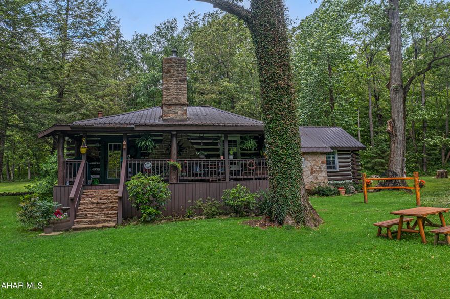 Discover a truly one-of-a-kind rustic log home tucked away in a secluded wooded setting just off Route 30. Believed to be well over 100 years old, this historic property has been beautifully preserved and thoughtfully updated, blending timeless charm with modern comfort. Inside, you'll find stunning hardwood floors, vaulted wood ceilings, and a massive stone fireplace in the living room that creates a warm, inviting atmosphere. Each bedroom features its own cozy stone fireplace, adding to the home's authentic character.

The kitchen and bathroom have been tastefully updated to offer modern convenience while maintaining the home's rustic appeal. Enjoy peaceful mornings and serene evenings on the covered front and back porches, or explore the property's 2.59 acres, complete with two ponds with a fountain, a stone spring house, and a storage shed.

Whether you're looking for a full-time residence or the perfect weekend escape, this property offers unmatched tranquility and charm. Located just minutes from Laurel Mountain Ski Resort, Seven Springs, the Quemahoning Reservoir, Jennerstown Speedway, and historic Ligonier. The home features both well and spring water sources, and an adjacent farm is also available for purchase. This is a rare opportunity to own a beautifully updated piece of rustic Pennsylvania history.