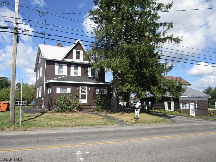 Two story home featuring 4 bedrooms, cherry kitchen, large living room, den that could be used as a 1st floor bedroom and 1.5 baths. Nice attic storage. Two heating systems - coal and oil.   Shop building (was rented at one time), two car detached garage with paved drive, ab gd  pool in enclosed building with outdoor furnace to heat it, and a storage building. Nice grounds including many fruit trees (peach, apple, pear and blueberry).
