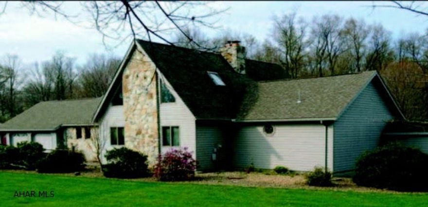 Beautiful 3+ Bedroom Ranch style open floor plan, home, 6.3 acres. 2 car attach garage. Real field stone fireplace with pellet insert in sunkin living room with cathedral ceiling with three oak beams. Large loft overlooking the living room. Oak flooring in dining area and oak trim throughout the home.  Full finished basement with fourth bedroom, living room, wet bar, brick fireplace with pellet insert and 3/4 bath, with outside entrance.  Outside covered pavillion with electric and water, cable and phone and fireplace. Small wood garden/ utitliy shed.  Brick paver patio and sidewalks. Beautiful river rock landscaping throughout the yard. 30X40 pole barn with all utilities, coal/wood burner, fully insulated and finished interior, hold two plus vehicles. Five zone hot water baseboard heat.