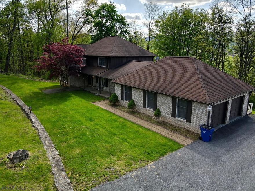 Leave the hustle and bustle of city life behind and enjoy the absolute wonder and joy that come from home ownership is this delightful town nestled in the Alleghany Mountains.  Pearched high above the historic town sits this majestic brick home in a peaceful and tranquil spot in the very desirable Meadowbrook Terrace.  If working from home and in need of high speed internet, this home definitely delivers.  Imagine cooking in the large kitchen and relaxing by the stone fireplace as you take in nature through the home's many large windows.  Huge rooms allow ample space to entertain and enjoy the warmth of a home of this stature.  This is a home that has been cherished and enjoyed by its present owners and will make the next owners proud to call this place home.