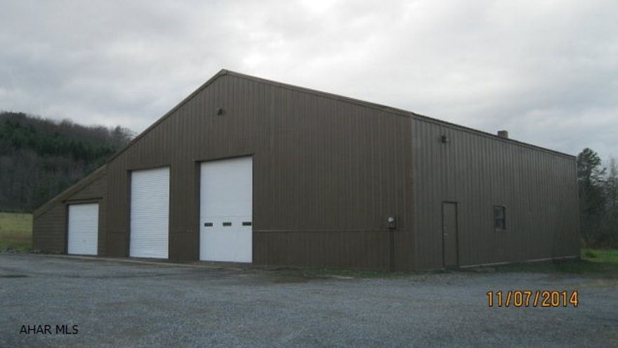 Steel & mansonry garage.3 OH doors, waste oil heat, toilet room. 1.66 acre lot.