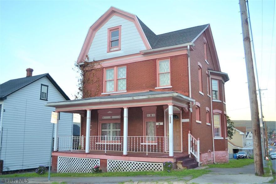 HUGE PRICE DROP!!! --  PLENTY of potential & possibility in this brick 4 bedroom, 1 bath home located on a double corner lot!  First floor has a nice sized living room, dining room, and kitchen. Upstairs are 4 bedrooms and the main bath.  The finished attic area is walk-up and could be used as livable space as well.  Home is centrally located across from Vets Field.  Covered front porch to enjoy and small covered back porch overlooks the large, spacious yard. Newer forced air furnace and roof. Insulation added in home as well.  House offered for sale AS-IS. Schedule your showing today!