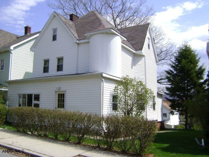 Large stately home on double lot.  Large family room on 1st floor.  4th bedroom on 3rd floor.  1 3/4 bathrooms.  2 zoned heat.  4 car off street parking.  Beautiful stained glass transom window, intricate woodwork, & two fireplaces.  Needs TLC.