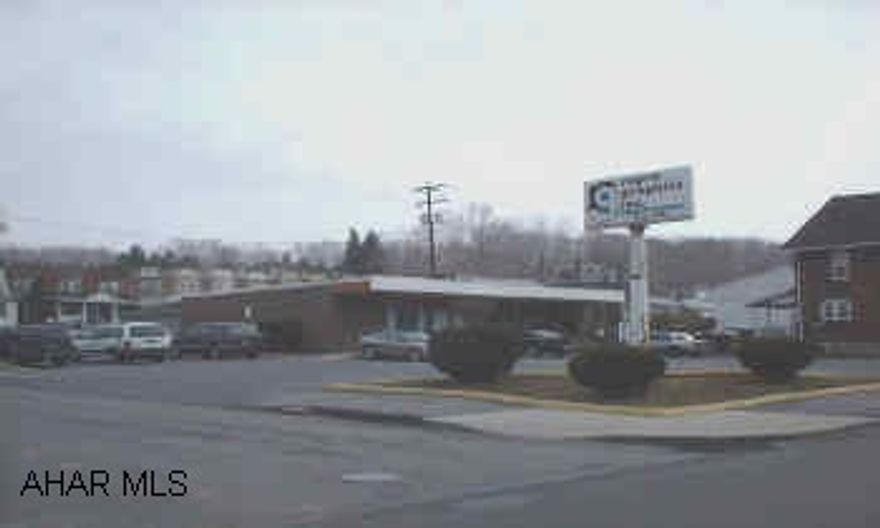 One story brick office building with great location on Sixth Avenue and ample off street parking