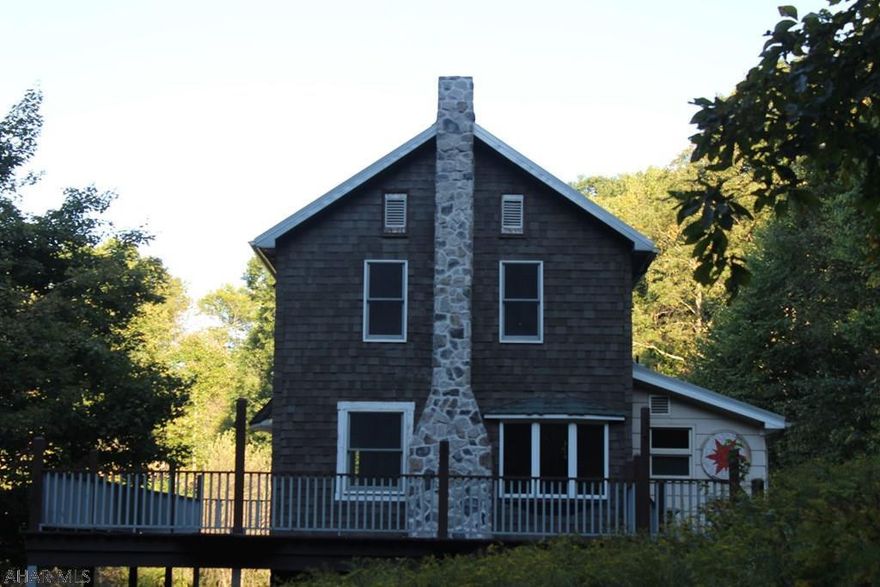 3BR/1BA secluded wooded mountainside home on a wooded 11.47ac. w/ 3 sided wrap around deck. Drive-way has three drainage receptacles. New metal roof, soffit, facia, gutters & attic insulation. Newer Bathroom w/ separate Bath & Shower accommodations. Newer Geo Thermal HVAC system for heating & cooling. Newer water heater & softener. New two phase well water pump. Granite counter tops in kitchen & bathroom. New carpet. Natural slate tile. Buried electrical lines for a non-obstructed view of Blue Knob State Park. Near Blue Knob Ski Resort, Clubhouse, golf course, community pool, hunting, fishing & Historic Downtown Bedford. This is a must see!  All measurements are approximate, buyers to verify SQFT.