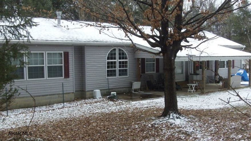 Just reduced! Are you looking for spacious rooms with lots of windows to brighten things up? This elegant double wide, situated on two lots, has room(s) to spare.  The master bedroom with large attached bath includes both a soaking tub and a shower.  The walk-in closet offers ample room for an extensive wardrobe.  The living room, dining room and kitchen boast laminate flooring and an open floor plan.  Warm up on chilly nights in front of the fireplace.  Truly a working kitchen, there is counter space along with an island for all of your culinary exploits.  Don't forget two additional bedrooms and another full bath.  Add an office area, laundry room and foyer area, all with storage areas.  Expensive?  No, come take a look at this affordable gem. Home warranty included. In Glendale Yearound