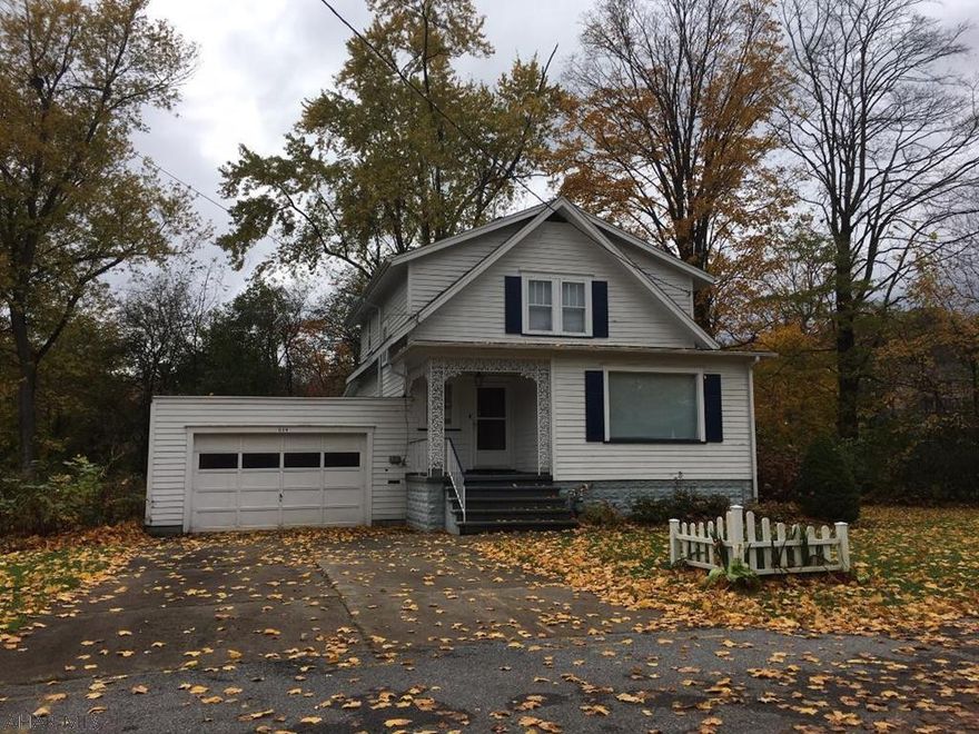 Privacy abounds for this two bedroom home located on a dead-end street in Llyswen.  Large living room, formal dining and family rooms.  Combination half bath-laundry room off family room.  Newer Trane furnace/central air.  Fenced section of yard for small children or pets.   Property being sold "as is-where is".  Needs some TLC and updating  Includes a separate, large block garage which has separate furnace and 60 AMP electric service; could provide extra rental income.  Equipped with two overhead doors.  Flood insurance is required, see quote in Documents.