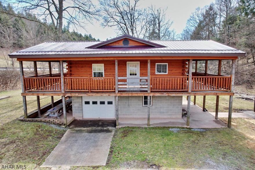 Come sit on the porch and watch the water roll along the babbling brook from this hemlock sided raised ranch home.  This home is nestled in Madley Hollow part of the hills of Bedford County Pennsylvania.  The views and wildlife abound.  The home offers a custom kitchen with quartz countertops, custom pine cabinets, and appliances.  Custom bath with stand up shower, soaking tube, and laundry on the main floor. Radiant hot water floor heat and pine walls throughout give it a cozy warm feeling.   If you are looking for a dream home in the woods, vacation home, or second home this is worth checking out. Only 2 miles from state game lands.  Motivated seller!