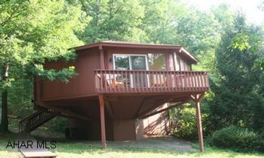 Fantastic home in the woods! Fantastic home in the woods! Contemporary octagon-shaped house with lots of windows to bring the outside in. Nestled amongst the trees; great location, across from Bedford Springs Resort golf course. Open floorplan, kitchen, dining area, living room, 2BR/2BA on main level. Spiral staircase leads to lower level family room. New windows, heat pump, roof, floor coverings. Peftect for a second home or someone who wants low maintenance. Relax and enjoy the outdoors on one of the decks.