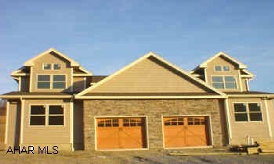Highly desirable 3 BR duplex, brand new construction, cedar-shake look vinyl & stone exterior, LR, DR, Kitchen, 2 BA, master suite, cathedral ceilings, walk-in closets, gas fireplace. Breathtaking views! Association fee $41/mo. covers grass, snow, and garbage. Listing agent has ownership interest.
