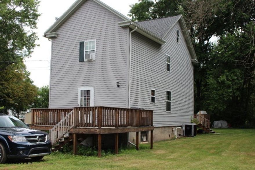 Charming house perfect for first time home buyers! Two Large decks surround this home. Newer siding and updates throughout. Simple but classic layout in this traditional home with contemporary accents. Hard wood doors bring the cozy feeling of country living to this city home. Impressive yard and off street parking! A Must See!! Schedule your showing today!