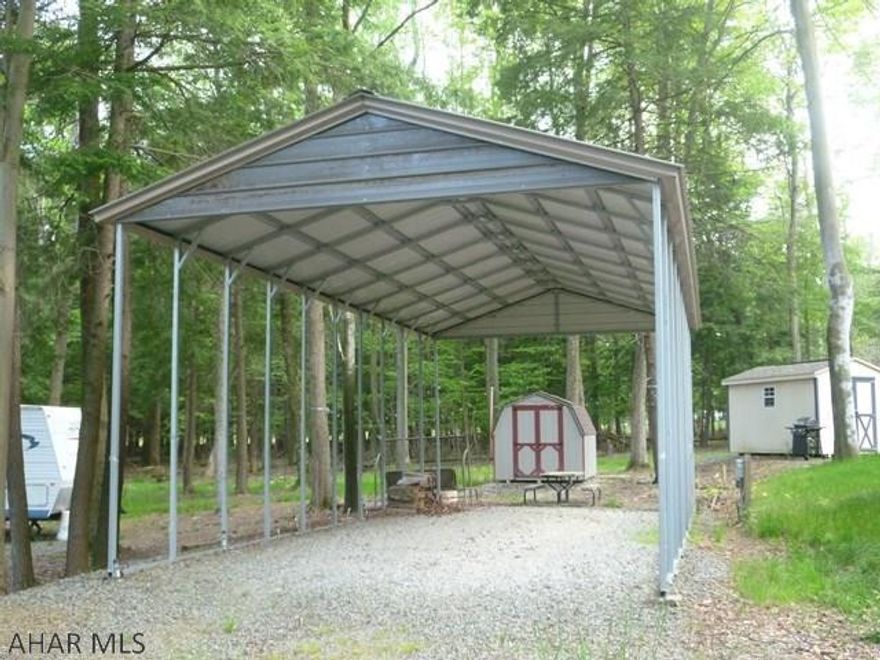 Do you love to camp but are tired of hauling your camper around and wasting your time setting up and taking down?  Look no further!  Park your camper under this 40' metal pavilion to both protect your camper and offer you outside use no matter what the weather may bring.  The shed, which has electricity,  gives you storage for the extras you bring along.  There is also a refrigerator inside that is included. This campsite is located in Glendale Yearound, a gated community adjacent to Prince Gallitzin State Park / Glendale Lake, that offers recreational facilities such as community pool, tennis/basketball/tennis courts, horseshoes, pavilions, playgrounds, dog park, club house and planned events for the whole family.  Rock Run ATV  park is only six miles away.  Come see what you are missing!