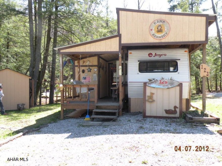 Get get away, spotless 30' Jayco w/ pavilion, additional room w/heat, summer kitchen, shed w/attached golf cart garage, 2 beautiful lots w/ stream. Golf cart negotiable. Motivated seller- seller will consider selling separately
