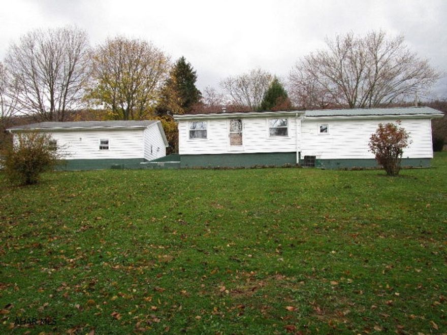 This property contains a single-wide mobile home on a full foundation.  Living room, kitchen, two bedrooms, full bath and a bonus room that can be used as a 3rd bedroom.  Updated metal roof, replacement windows, oil forced air heat and central air conditioning.  Large detached two-car garage, storage shed and large yard.  This mobile home has been very well maintained and is very affordable.  Convenient location on the edge of the borough.